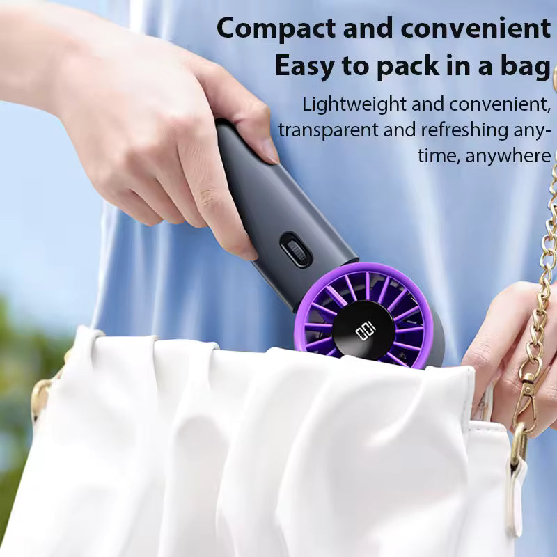 Person holding a Travel Turbine Fan, showcasing its compact design for easy packing.